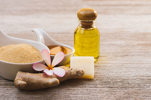 Ginger powder and honey soap isolated on wood table background. Beauty and spa product concept.