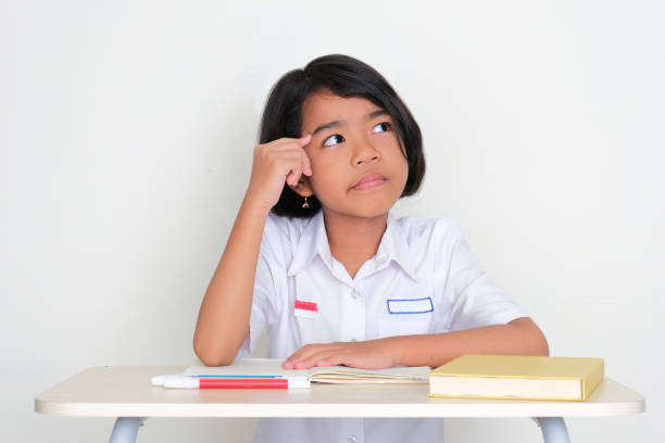 Indonesian young student looking to the left side thinking about something