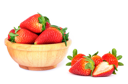 Fresh organic red berry strawberry in wooden bowl isolated on white background.