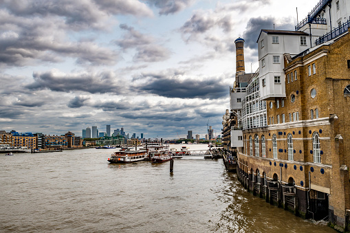 River Thames With Boats And Docks Beneath Butler's Wharf From Tower Bridge In London, United Kingdom