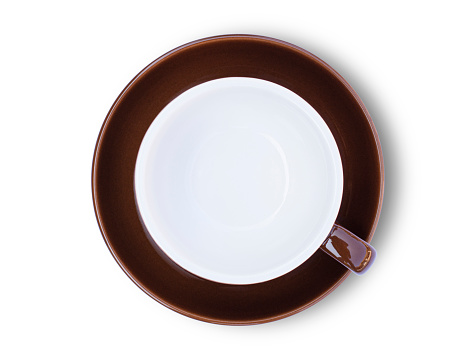 Empty dark brown cup of coffee with saucer isolated on white background with clipping path.