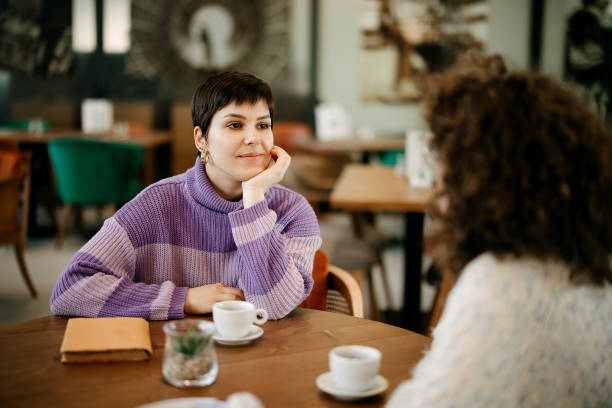 istock Two student friends are sitting in a cafe 2037915515