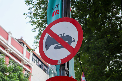 a sign depicting a trumpet prohibits honking car horns. surabaya, indonesia - 21 february 2024
