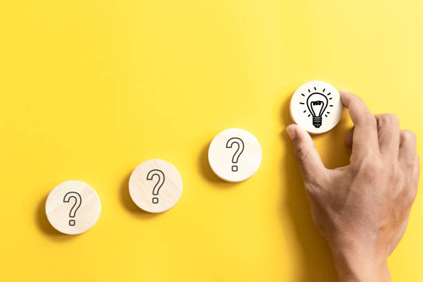 istock Hand holding wooden block with light bulb icon and questions mark for for creative thinking idea and problem solving concept. 2037921264