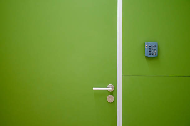 Close-up green door with coded door lock or code keypad on a soft green background and light for concept of Interior design and home safety.
