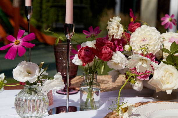 istock Elegant table setting with variety of fresh flowers and dishware. Content related to event planning and aesthetic design for summer party picnic. 2037925523