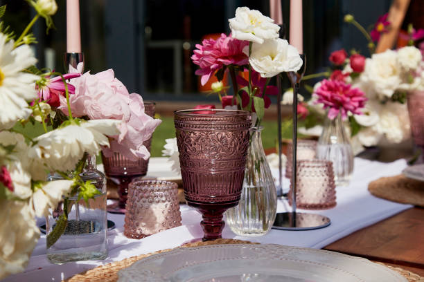 istock Picnic aesthetics table setting, flowers arrangement. Decorating table with white and pink blooms. Outdoor entertaining and decoration 2037925526