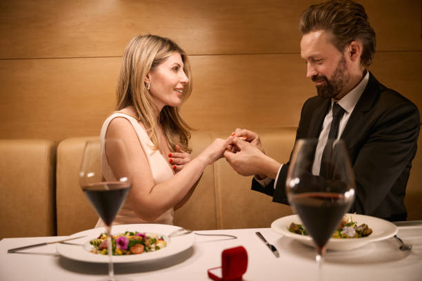 istock Man puts a wedding ring on his companions finger 2037926093