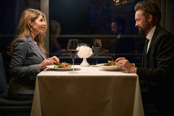 istock Man and a woman communicate over dinner in cozy restaurant 2037927190
