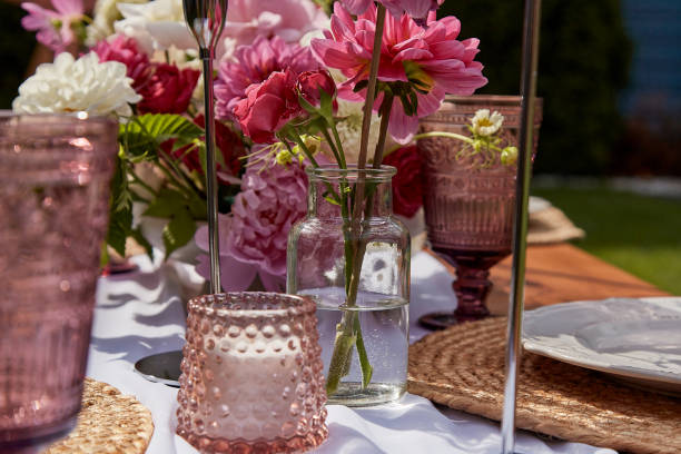 istock Candle in decorative arrangement, surrounded by blooms. Table aesthetics and design, summer picnic party 2037931008