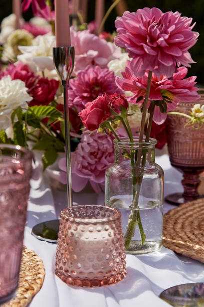 istock Romantic table arrangement with candle and vibrant flowers. Table aesthetics and design, summer picnic party 2037931009