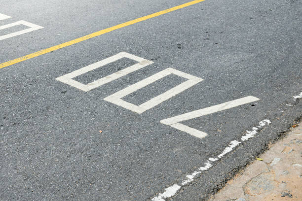 istock Road surface and yellow traffic lines with numbers seven hundred or 700 on soft sunlight background. 2037931028