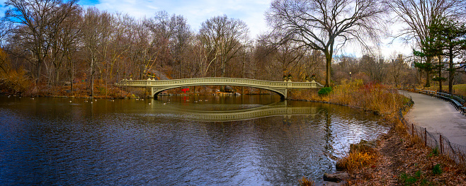 Central Park Winter landscape with the Bow Bridge, a scenic pedestrian footbridge in Manhattan, New York City, USA