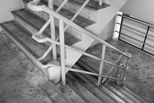 Concrete stairs in a building or fire escape in a gray background tone, used for decoration and design.