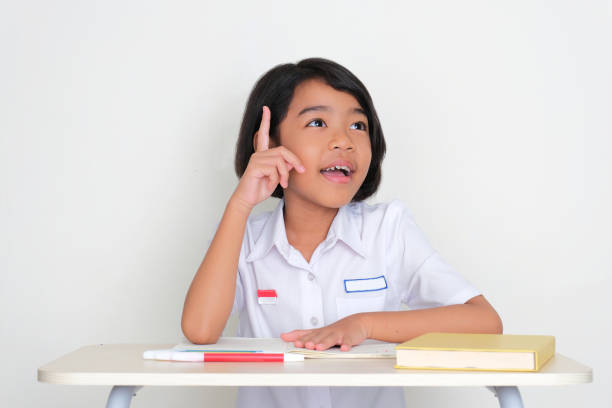 Indonesian kid student find new idea when sitting on school desk