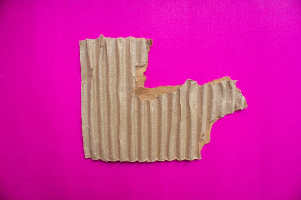 istock Ripped cardboard paper piece isolated on pink background 2037954281