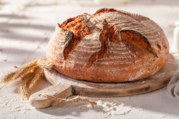 istock Homemade round loaf bread on wooden cutting board. 2037968954