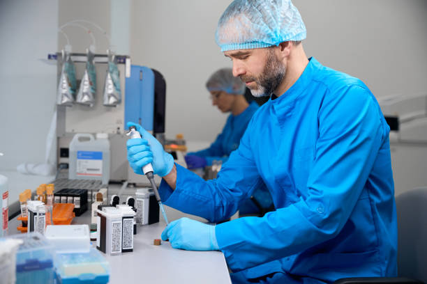 Male laboratory assistant examines biological material in a modern laboratory