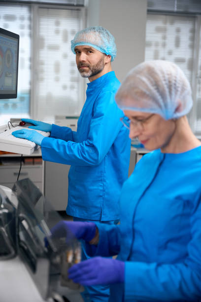 istock Laboratory employees use high-tech equipment in their work 2037985062