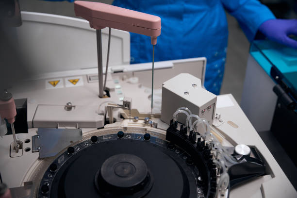 Laboratory assistant immunologist uses a device for automatic isolation of nucleic acids, modern equipment in the laboratory