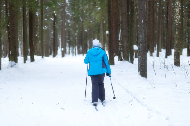 Syktyvkar, Komi Republic, Russia.On February 25, 2024, people ski in winter on a ski track through a winter forest.Cross-country skiing.