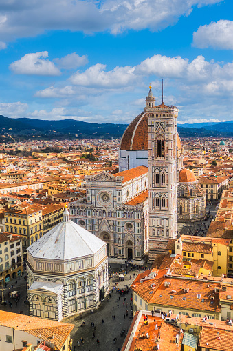 Vertical aerial cityscape view on the dome of Santa Maria del Fiore church and old town in Florence.