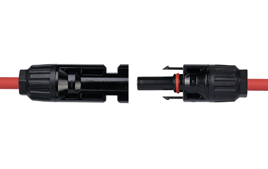 Two MC4 electrical connector fastened to a red cable, ready for secure outdoor electrical installations.