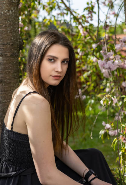 istock Cool girl is posing near sakura tree. 2038052406
