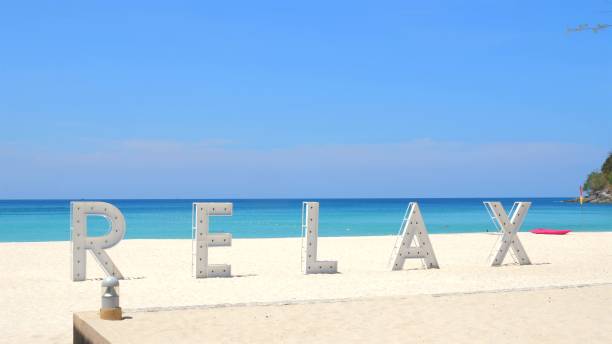 istock Serene beach scene with large 'RELAX' letters on white sand against 2038072328