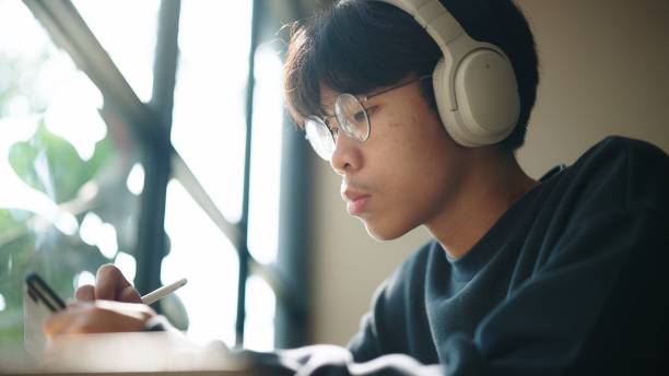 istock Teenager working on digital tablet at cafe. 2038092727
