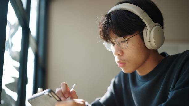 istock Teenager working on digital tablet at cafe. 2038092731