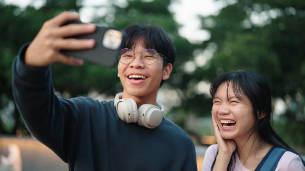 Teenager taking selfie while traveling together.