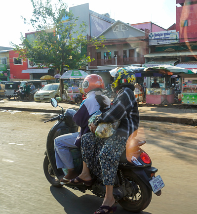Phnom Penh, Cambodia -December 12, 2023: road from Siem Reap to Phnom Penh. people on a motorbike