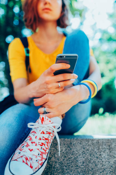 istock Depressed girl texting at the park 2038122056