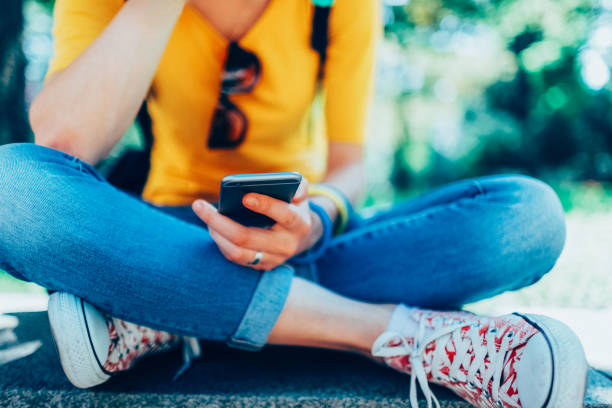 Depressed girl texting at the park