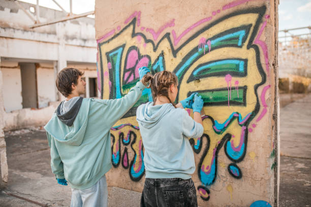 istock Rear view of two artists drawing graffiti and creating their art 2038138716
