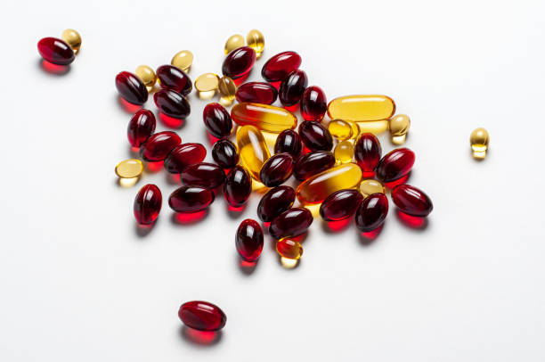istock Pile of Red and Yellow Pills on White Surface, Tablets vary in size, creating a visual contrast 2038148445