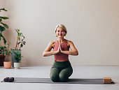 Senior Woman Smiling During Yoga Practice at Home