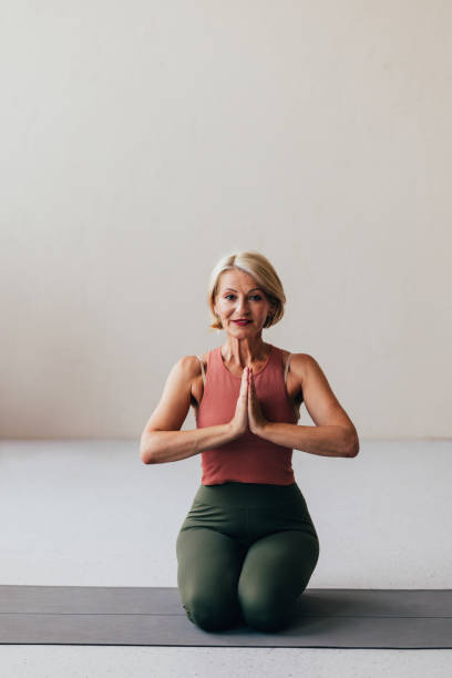 istock Mature Woman Practicing Yoga in a Peaceful Indoor Setting 2038148999