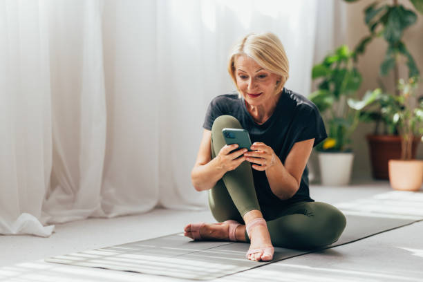 istock Senior Woman Engaged with Smartphone in a Bright Home Environment 2038149545