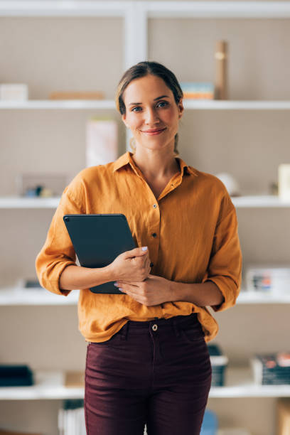 istock Confident Professional Woman Holding Tablet in Modern Office 2038157612