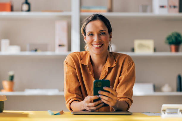 istock Confident Businesswoman Using Smartphone in Modern Office 2038157630