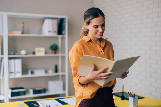 istock Professional Woman Reviewing Documents in Modern Office Environment 2038157639