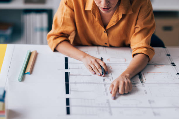 istock Architect Reviewing Blueprints in Office, Focused on Design Work 2038157649