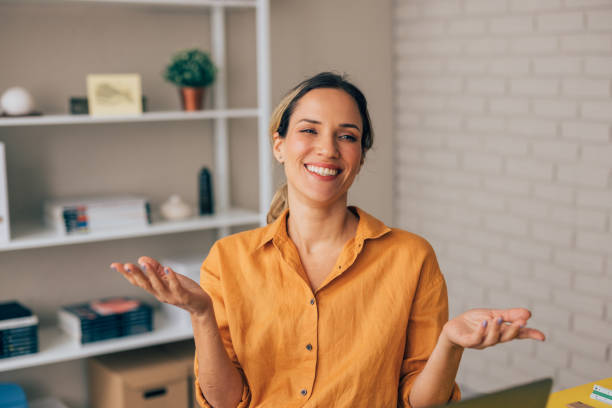 istock Smiling Businesswoman Gesturing in Modern Office Setting 2038158186