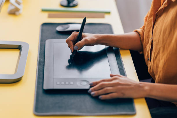 Graphic Designer Working on a Tablet at a Creative Modern Desk