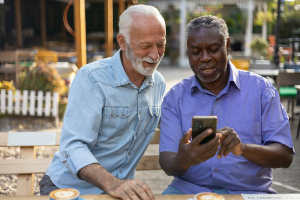 istock Two Diverse Senior Male Friends Having Coffee Break 2038164214