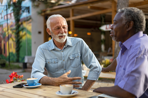 Diverse Senior Men Bonding Outdoors in the Coffee Shop. Concepts About Elderly Lifestyle