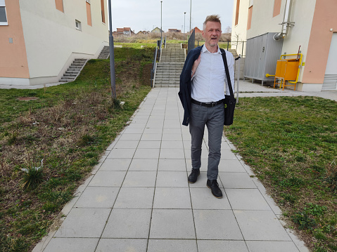 Man is walking to his work place because public transport nor working