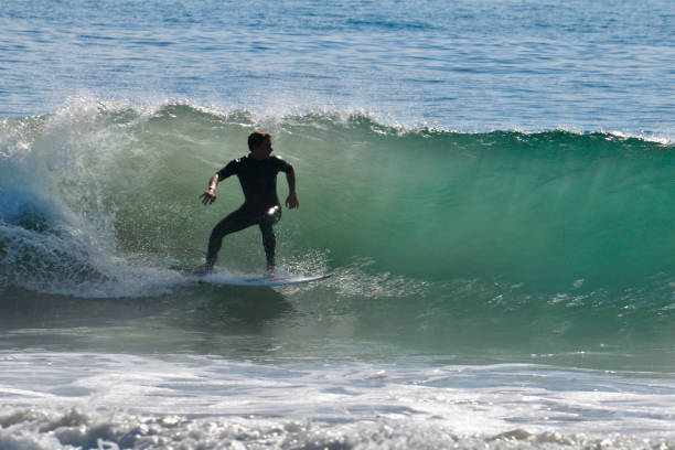 istock Surfer Racing the Break on a Sunlit Wave 2038186546